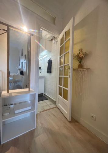 - un couloir avec une salle de bains pourvue d'un miroir et d'une porte dans l'établissement Dream Dwell Paris-Charming Studio superb location in 7th district Paris, à Paris