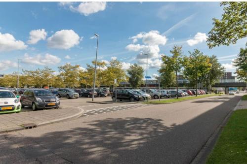 a parking lot with a lot of cars parked at Family house next to train and close to Amsterdam and Schiphol in Almere