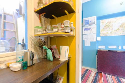 a kitchen with a counter and a shelf at Shantihome in Izmir
