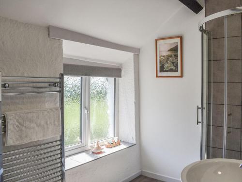 a bathroom with a window and a sink at Uk40277 - Llys Elen Two in Brynsiencyn