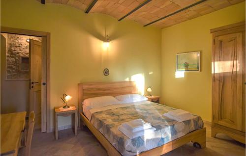 a bedroom with a large bed with a wooden headboard at Awesome Apartment In Avigliano Umbro With 2 Bedrooms And Wifi in Avigliano