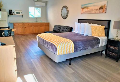 a bedroom with a bed and a sink in it at Johns Pass Beach Motel in St Pete Beach