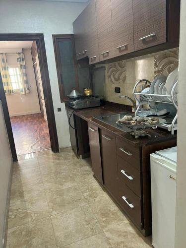 a kitchen with a sink and a counter top at Appartement calme au centre ville in Casablanca