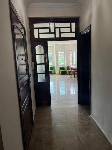 a hallway with a door and a living room at Appartement calme au centre ville in Casablanca