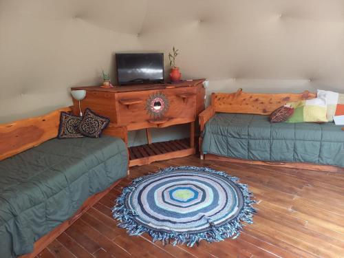 a living room with two couches and a television at Domo Cielos del Uritorco in Capilla del Monte