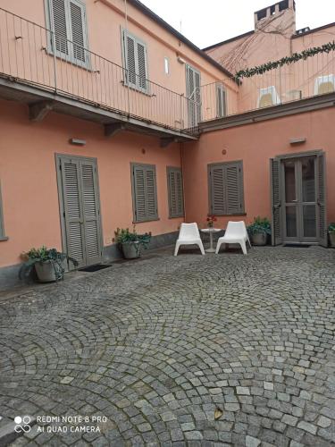 a group of chairs sitting outside of a building at Residenza il Nespolo - Estella Hotel Collection in Turin