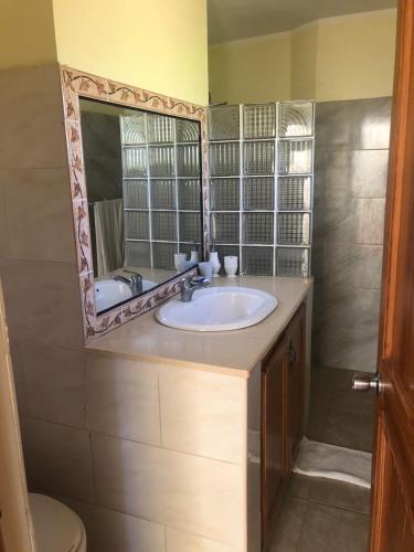 a bathroom with a sink and a mirror at Hotel Cambri in Nagua