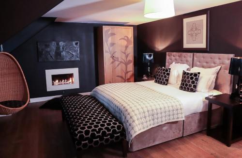 a bedroom with a bed and a fireplace at Tigerlily in Edinburgh