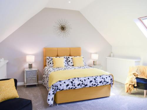 a bedroom with a bed and two lamps and a chair at The Coach House At Mount Pleasant in New Shildon