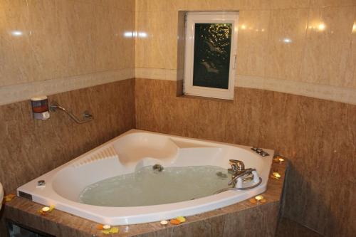 a large bath tub in a room at Exis Hotel in Athens