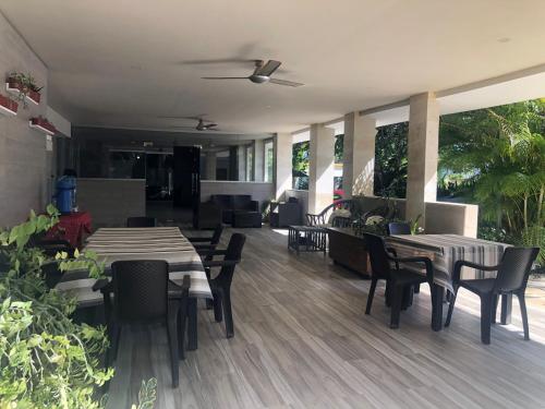 a restaurant with two tables and chairs and tables and chairs at Hotel Cambri in Nagua