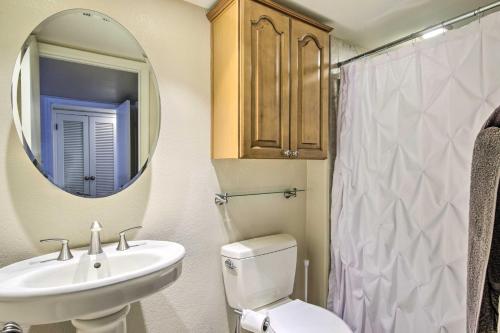 a bathroom with a sink and a toilet and a mirror at Scottsdale Condo about 2 Mi to Downtown! in Scottsdale