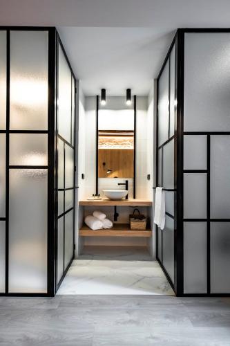 a bathroom with a sink and a mirror at ABBI Suites Casa Rural, Suites & Spa in Bocairent