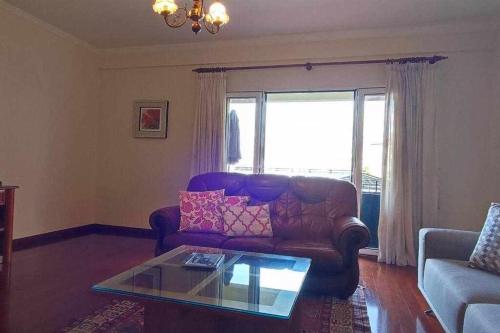 a living room with a couch and a coffee table at SeaBreezeBonimar in Funchal