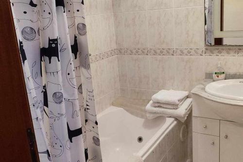 a bathroom with a shower curtain and a sink at SeaBreezeBonimar in Funchal