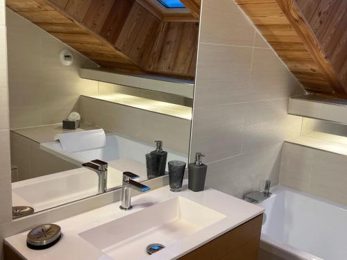 a bathroom with a sink and a mirror at Appartement 201, Duplex avec terrasse et garage in Montgenèvre