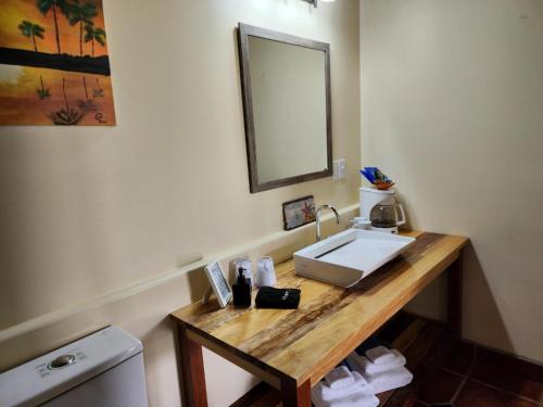 a bathroom with a sink and a mirror at The BNB on Triggerfish Close to the airport in Ladyville