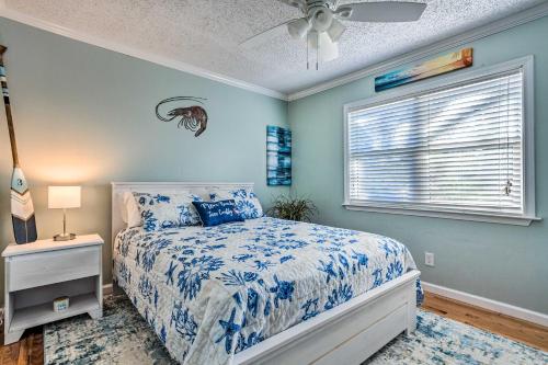 a bedroom with a bed and a ceiling fan at Serene Pensacola Vacation Rental with Gas Grill in Pensacola