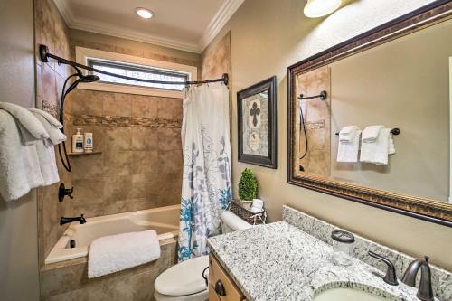a bathroom with a tub and a toilet and a sink at Spacious Golf Course Getaway in Hot Springs! in Hot Springs Village