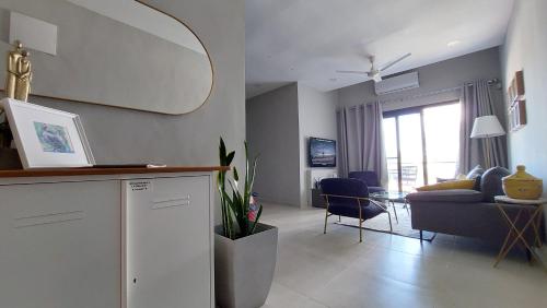 a kitchen and living room with a couch and a table at Superbly Modern and Airy Two Bedroom Seaside Apartment with Balcony in Bijilo