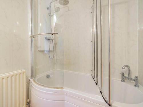 a bathroom with a shower and a bath tub at Galena in Glenridding