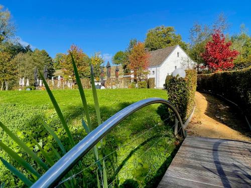 a wooden walkway leading to a house in a yard at La Bel échappée in Aubel