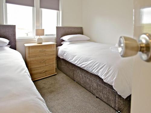 a bedroom with two twin beds and a night stand at Rockworks Chalets No,5 - Uk7044 in Saint Marys