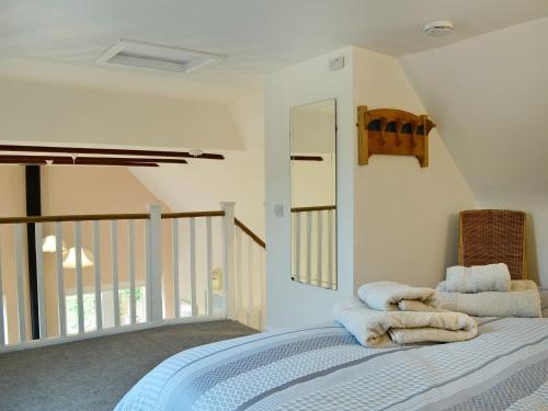 a bedroom with a bed with towels on it at Bridge Cottage in New Channelkirk