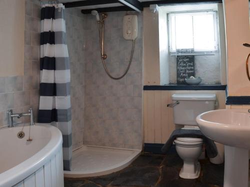 a bathroom with a tub and a toilet and a sink at Brambley Meadow- Uk11725 in Kentisbury