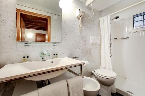 a white bathroom with a sink and a toilet at Leo APARTMENT LOC-03081 in Venice