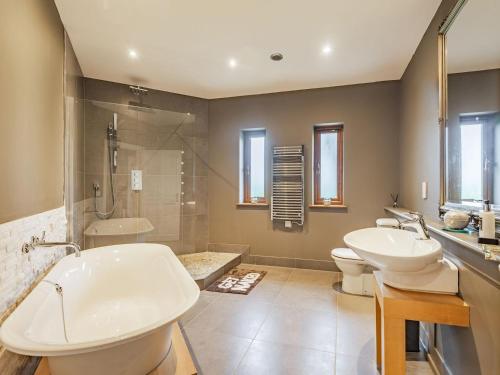 a bathroom with two sinks and a toilet and a shower at Hoole Summer House in Elswick