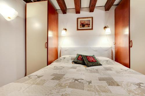 a bedroom with a bed with two pillows on it at Leo APARTMENT LOC-03081 in Venice