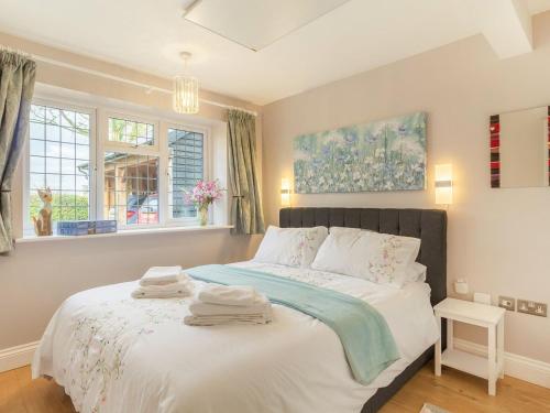 um quarto com uma cama com toalhas em Garden Cottage em Burgh