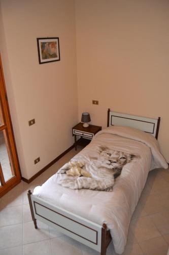 a bedroom with a bed with a dog laying on it at La Filanda B&B in Casorezzo