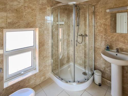 a bathroom with a shower and a sink at Filey House in Sheringham