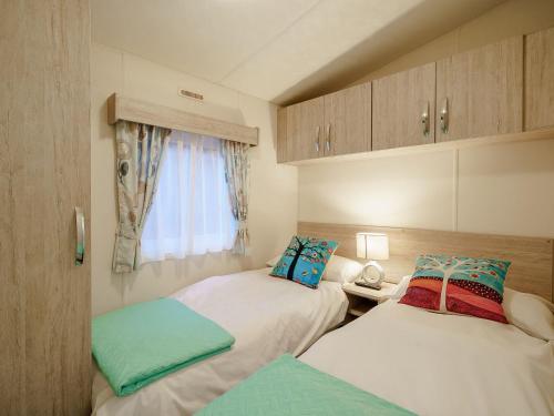 two beds in a small room with a window at The Paddocks - Uk7112 in Dollar