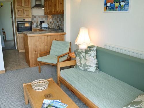a living room with a couch and a chair and a table at Lowenna - Ukc3538 in Mevagissey
