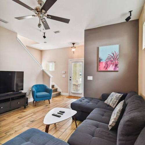 a living room with a couch and a tv at 2 King Bed Hot Tub Home in Tampa