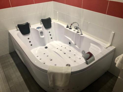 a bath tub with two towels in a bathroom at AYATO l’auberge de l’abbaye in Sorde-lʼAbbaye