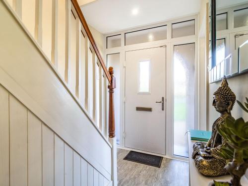 a hallway with a white door with a statue next to it at The Laurels in Clenchwarton