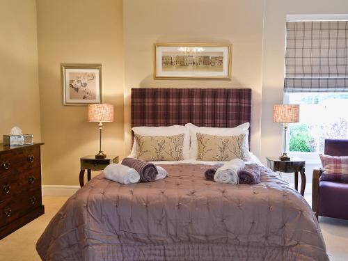 a bedroom with a large bed with towels on it at Awelfa - On7 in Aberaeron