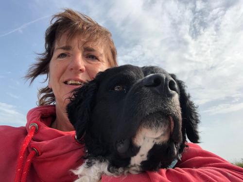 a woman holding a black and white dog at Vakantie Studio Grou in Grou