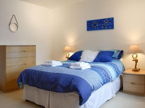 a bedroom with a bed with towels on it at Cotton Shore in Inverallochy