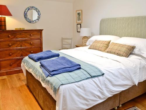 a bedroom with a bed with towels on it at The Barn in Greystoke