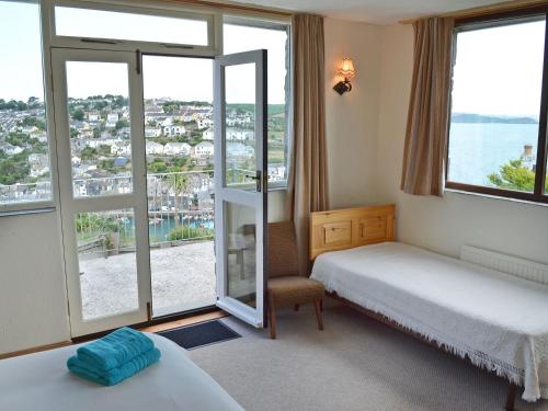 a bedroom with two beds and a large window at Berlewen - Ukc3536 in Mevagissey