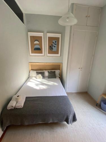 a bedroom with a large bed with two towels on it at Center Madrid habitaciones in Madrid