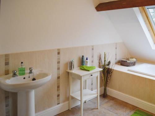 a bathroom with a sink and a bath tub at St Albans Church - 28165 in Treherbert