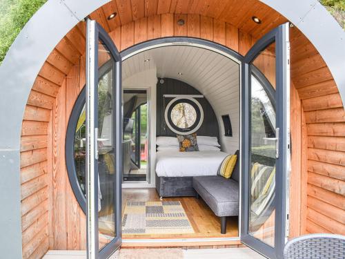 a bedroom inside of a tiny house with an arched doorway at Shiel - Uk39866 in Salen