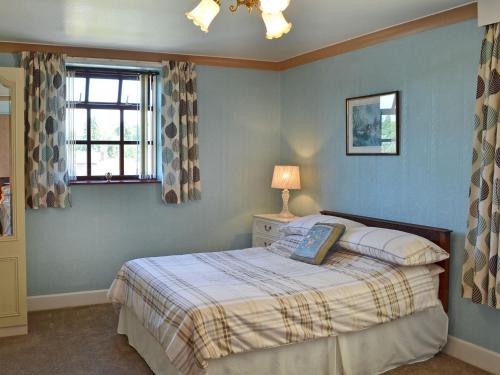 a bedroom with a bed and a window at High Bank in Bunbury