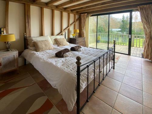 a bedroom with a bed with two dogs laying on it at The Old Carthouse in Steyning